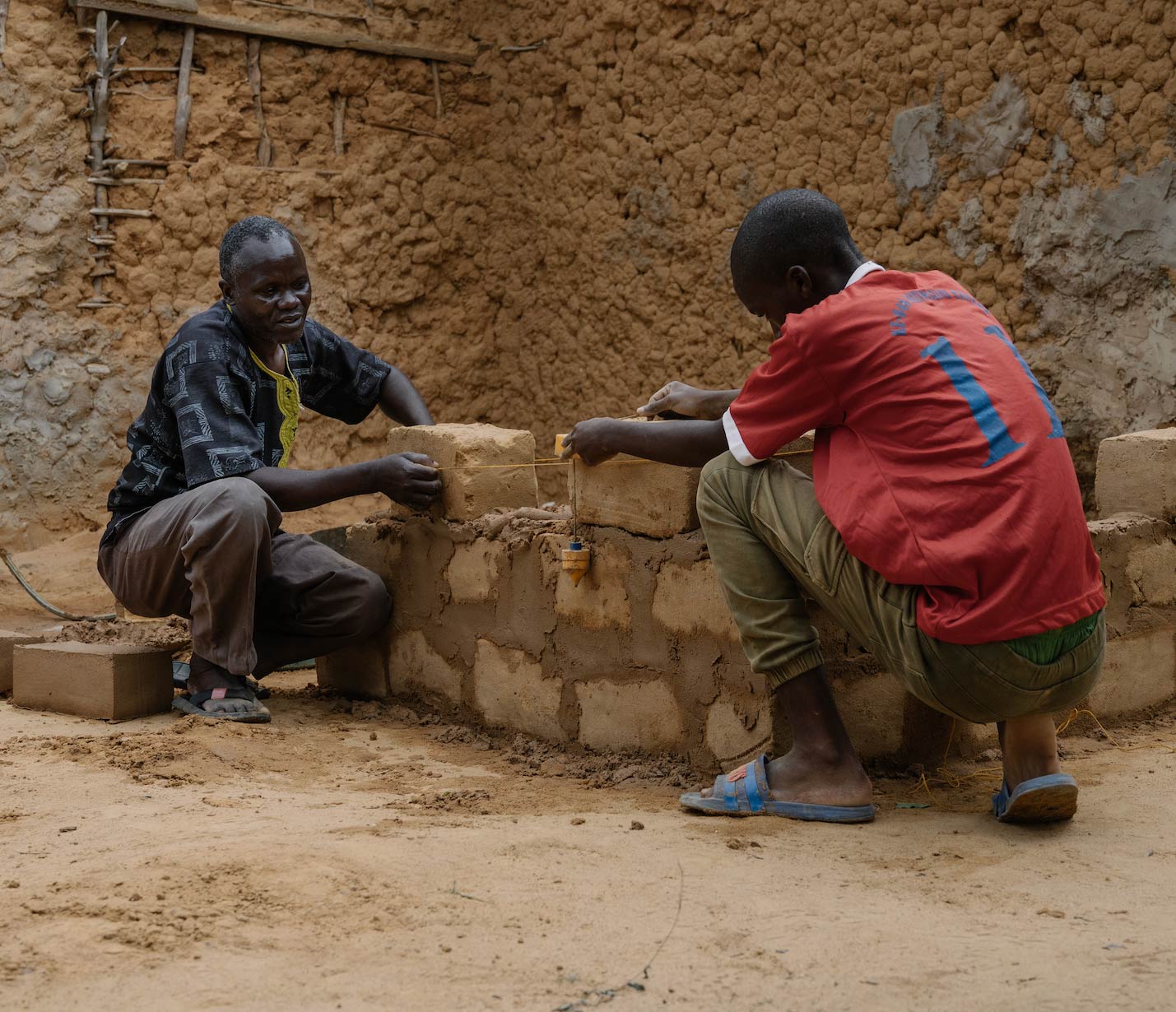 men laying bricks